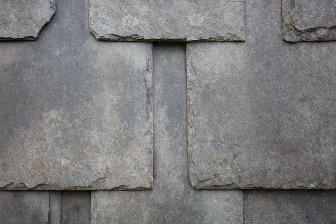 Overlapping gray stone slabs forming an abstract geometric pattern